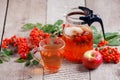 Hot tea from rosehip berries and fruit in transparent glasses and honey on a wooden table. Harvesting, autumn fall winter hot