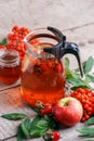 Hot tea from rosehip berries and fruit in transparent glasses and honey on a wooden table. Harvesting, autumn fall winter hot