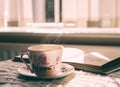 Hot tea with steaming in cinematic tone, Still life cuppa tea with steam on a coffee table with morning light shining from window,