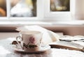 Hot tea with steaming in cinematic tone, Still life cuppa tea with steam on a coffee table with morning light shining from window