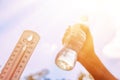 hot temperature,Thermometer and water bottle on sky with sun shining in summer show higher Weather Royalty Free Stock Photo