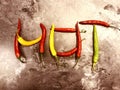 HOT text composed of colorful, red, green and yellow hot peppers Royalty Free Stock Photo