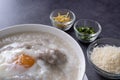 Hot Thai congee (rice porridge) with minced pork ball and boiled egg as breakfast Royalty Free Stock Photo