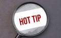 Hot tip word on paper through magnifying lens Royalty Free Stock Photo