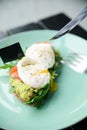 Close-up poached egg with yolk on toast with avocado and salad Royalty Free Stock Photo