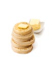 Hot toasted crumpets with butter slice isolated on white
