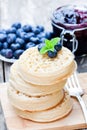 Hot toasted crumpets on the wooden table with blueberries and j Royalty Free Stock Photo