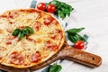 Hot true PEPPERONI ITALIAN PIZZA with salami and cheese. TOP VIEW Tasty traditional pepperoni pizza on board on white wooden table Royalty Free Stock Photo