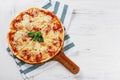 Hot true PEPPERONI ITALIAN PIZZA with salami and cheese. TOP VIEW Tasty traditional pepperoni pizza on board on white wooden table Royalty Free Stock Photo