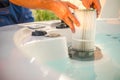 Hot Tub Technician Removing Water Filter and Performing Scheduled Garden SPA Maintenance Royalty Free Stock Photo