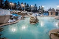 Hot tubs and ingound heated pool at a mountain village in winter