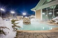 Hot tubs and ingound heated pool at a mountain village in winter