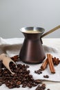 Hot turkish coffee pot, beans and spices on white wooden table Royalty Free Stock Photo