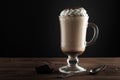 Hot viennese coffee with whipped cream on dark background