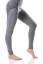 Hot view of fit woman legs from side in gray sports thermal underwear with pattern.