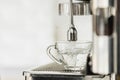 Hot water from coffee maker machine flowing into the cup Royalty Free Stock Photo