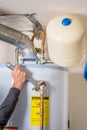 Hot water heater maintenance with a wrench Royalty Free Stock Photo