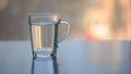 Hot water over tea in transparent glass cup