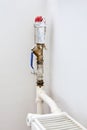 Hot water plumbing pipe and thermostat valve of a radiator Royalty Free Stock Photo