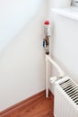 Hot water plumbing pipe and thermostat valve of a radiator Royalty Free Stock Photo