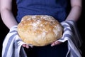 Hot wheat bread in baker`s hands