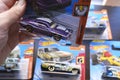 A Hot Wheels purple American custom die cast toy car from Muscle Mania series on hand