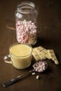 Hot white chocolate with cocoa bar and marshmallows on dark wooden background Royalty Free Stock Photo