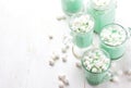 Hot white mint chocolate with marshmallows, white background. Holidey drink