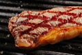 Hot Whole Grilled Chivas Beef Steak on Black Barbecue Grill Back