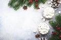 Hot winter drink with cocoa, chocolate and marshmallows in glass cups on gray background, top view, copy space Royalty Free Stock Photo