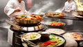 A hot wok with chef in a Chinese kitchen. back view of the chef, Chinese food being cooked in a wok on fire in the Chinese kitchen Royalty Free Stock Photo