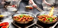 A hot wok with chef in a Chinese kitchen. back view of the chef, Chinese food being cooked in a wok on fire in the Chinese kitchen Royalty Free Stock Photo