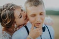 Hot woman showing tenderness man in garden. Portrait of sexy couple expressing feelings in park. Close up gorgeous bride Royalty Free Stock Photo