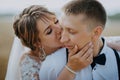 Hot woman showing tenderness man in garden. Portrait of sexy couple expressing feelings in park. Close up gorgeous bride Royalty Free Stock Photo