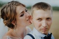 Hot woman showing tenderness man in garden. Portrait of sexy couple expressing feelings in park. Close up gorgeous bride Royalty Free Stock Photo