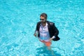 Hot working. Funny office worker in pool water. Business man in suit in sea or pool. Travel work and business concept