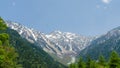 Hotaka mountain range and green tree in spring at kamikochi japan