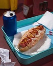 Hotdog with ketchup and mustard, a drink in a blue bottle