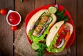 Hotdog with ketchup, mustard, lettuce and vegetables Royalty Free Stock Photo