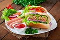 Hotdog with ketchup, mustard, lettuce and vegetables Royalty Free Stock Photo