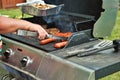 Hotdogs and steak on the grill at a backyard cookout Royalty Free Stock Photo