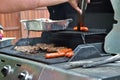 Hotdogs and steak on the grill at a backyard cookout