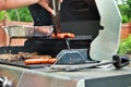 Hotdogs and steak on the grill at a backyard cookout Royalty Free Stock Photo