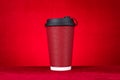 A hotdrink paper cup on a red background horizontal composition Royalty Free Stock Photo