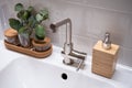 Hotel bathroom with sink, tap, flowers and bathroom set Royalty Free Stock Photo