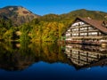 Hotel Bor and mountains in autumn colors reflecting Lake Crnava Royalty Free Stock Photo