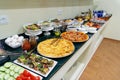 Hotel breakfast board in a family hotel. Buffet with different dishes.