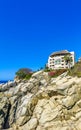 Hotel Condos Apartments on rocky cliff by sea and nature