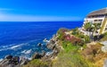 Hotel Condos Apartments on rocky cliff by sea and nature