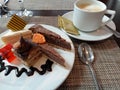 Hotel dessert plate with cakes, tarts and jelly served with tea.